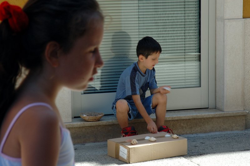 Pula普拉<br>賣著貝殼的小男孩，與家人度假的小女生，形成對比。<br/>